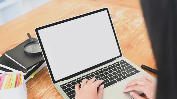 istock Close-up young woman typing laptop computer with empty screen 1185885192