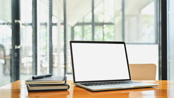 istock Mockup laptop, notebook and pen on wood table. 1185886137