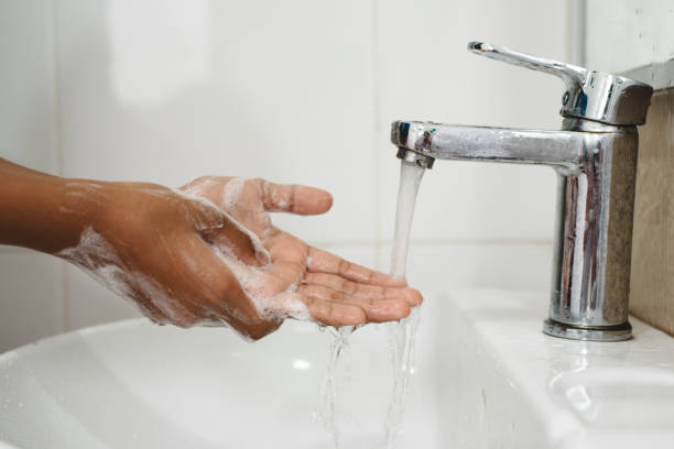 istock Cropped Image Of Person Washing Hands 1185886348