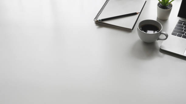istock Copy space office desk with laptop, notebook, pencil and coffee cup. 1185886502
