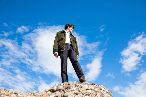 istock Man standing on a high place looking into the distance 1185886595