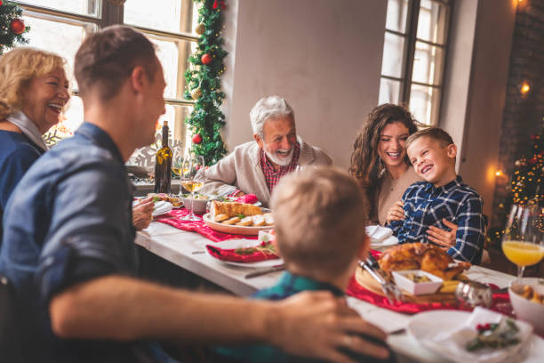 istock Family gathered for Christmas dinner 1185887589