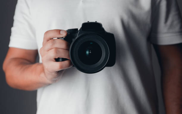 istock Photographer holding a digital camera 1185888385