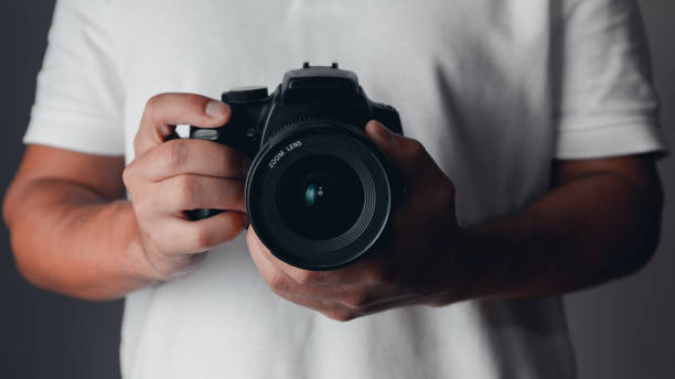 istock Photographer holding a digital camera 1185888386