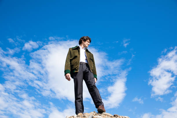 istock Man standing on a high place looking into the distance 1185888587
