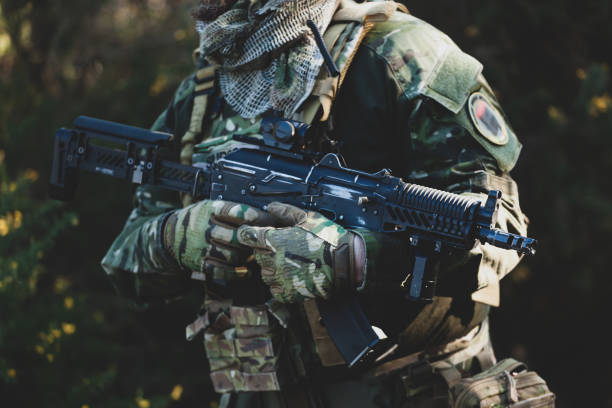 istock Midsection Of Soldier Holding Rifle 1185888913