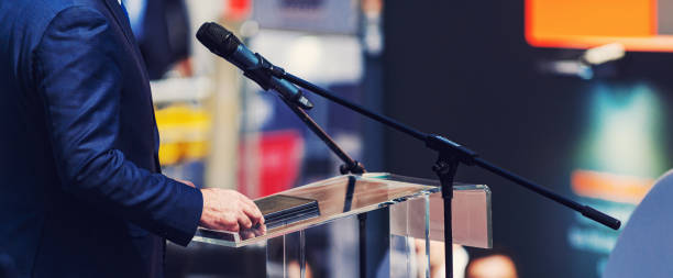 istock Midsection Of Man Holding Digital Tablet While Standing By Microphone 1185889161