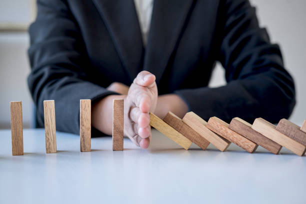 istock Midsection Of Businessman Playing With Toy Blocks On Table 1185890933