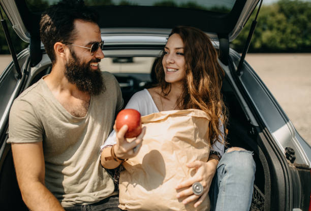 istock Young couple packing groceries 1185891488