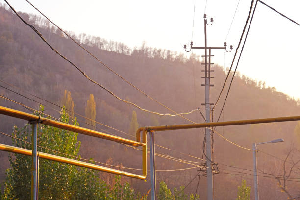 Electric wires and gas pipes in sunset sunlight