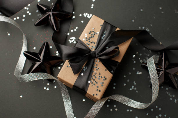 istock Christmas silver decor and handmade gift box on black background top view. Merry Christmas greeting card, frame. Winter xmas holiday theme. Happy New Year. Sale 1185895010