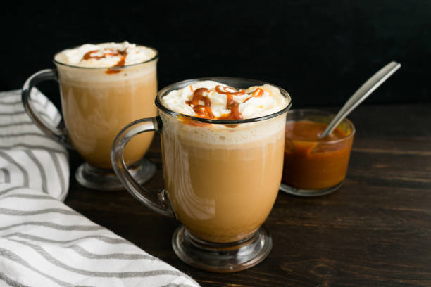 Caramel Brûlée Coffees in Glass Mugs Coffee with milk topped with whipped cream and caramel sauce cafe macchiato stock pictures, royalty-free photos & images