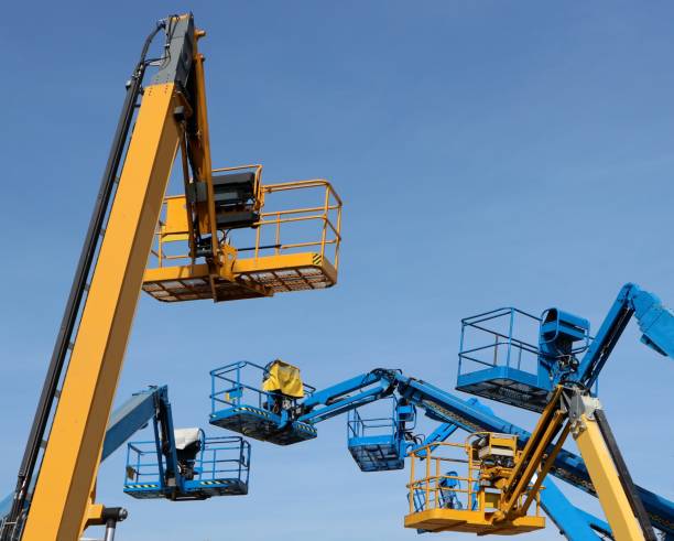istock Several aerial working platforms of cherry picker against blue sky 1185895275