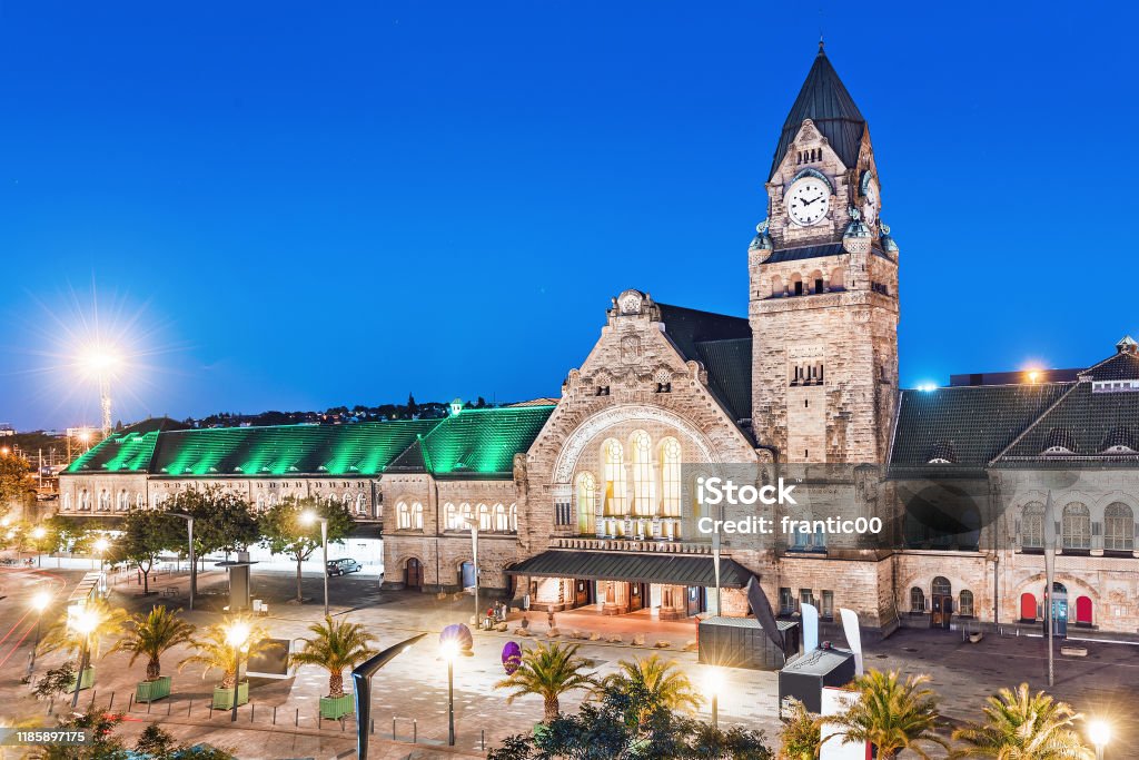 Night view of the illuminated old railway station building with clock tower in Metz city Metz Stock Photo