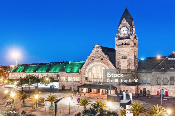 Night View Of The Illuminated Old Railway Station Building With Clock Tower In Metz City Stock Photo - Download Image Now