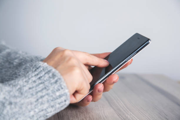 istock woman hand smart phone 1185897456