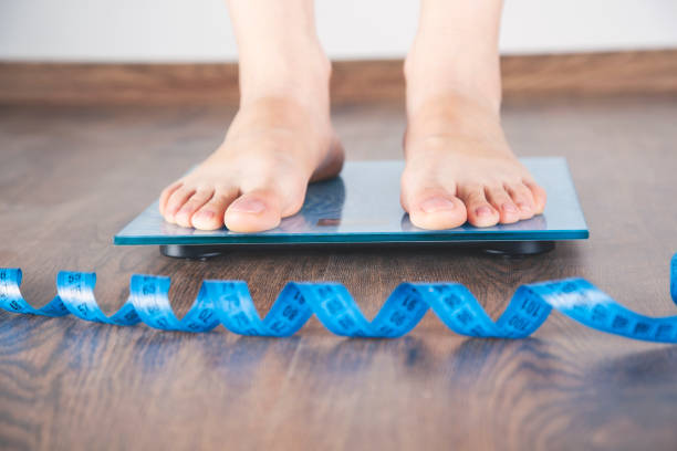 istock woman in scales with meters 1185897496