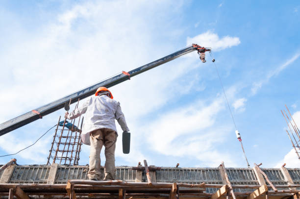istock Construction workers working on scaffolding with plaster and spatula,Man Working on the Working at height with blue sky 1185898686