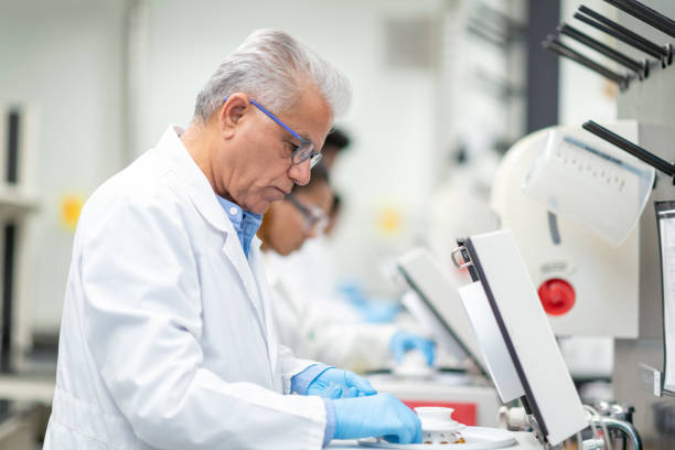 istock Mature Middle Eastern Scientist Putting Samples into a Centrifuge stock photo 1185898763