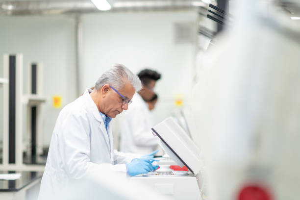 istock Mature Middle Eastern Scientist Putting Samples into a Centrifuge stock photo 1185898768