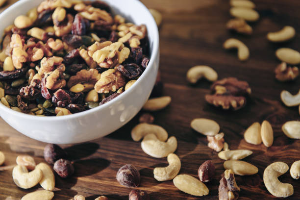 istock white bowl with mixed nuts on rustic wooden table 1185898812