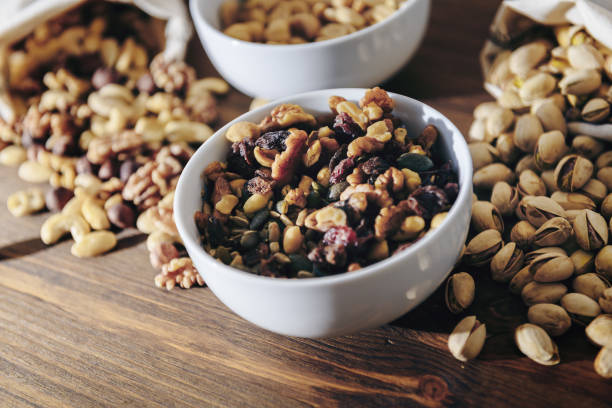 istock white bowl with mixed nuts and dry fruits 1185898827