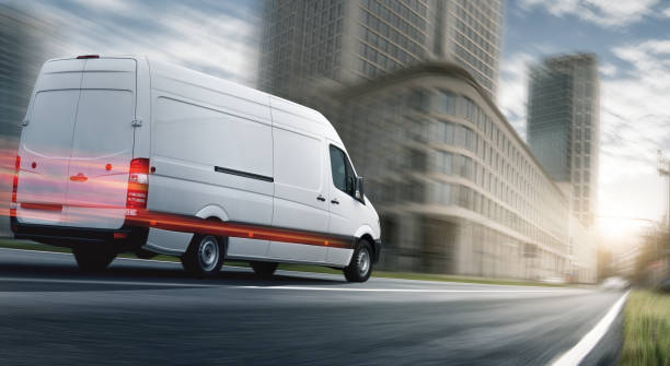 Delivery van delivers in a city Delivery van delivers in a city van vehicle stock pictures, royalty-free photos & images