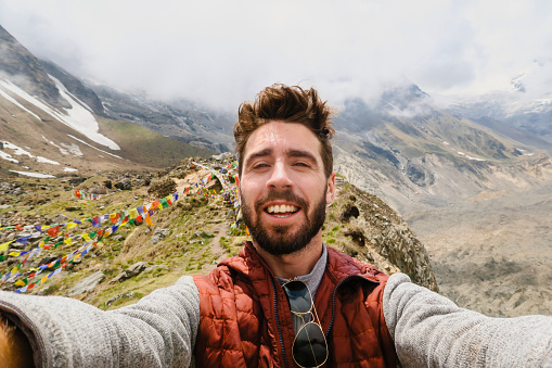 A selfie shot of a caucasian male tourist trekking in Annapurna Base Camp in Nepal.