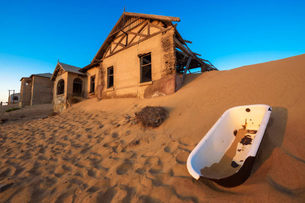 Empty bathtub in Kolmanskop ghost town, Namibia Empty bathtub placed outside in the sand desert around the ghost town of Kolmanskop. kolmanskop namibia stock pictures, royalty-free photos & images