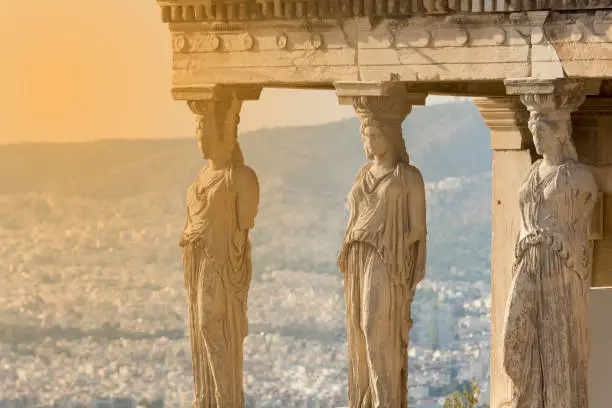 The karyatides statues at sunset inside acropolis of Athens