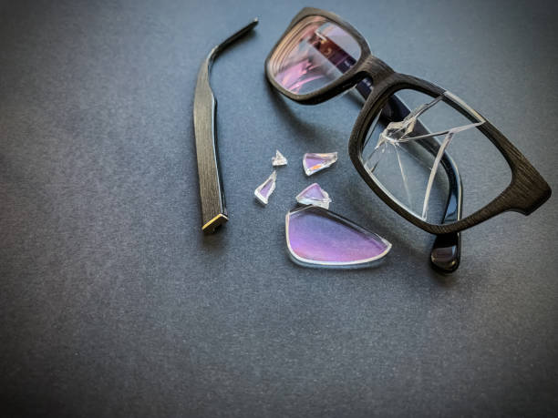 istock plastic glasses with a broken lens and a torn earhook on a dark background. 1185906810