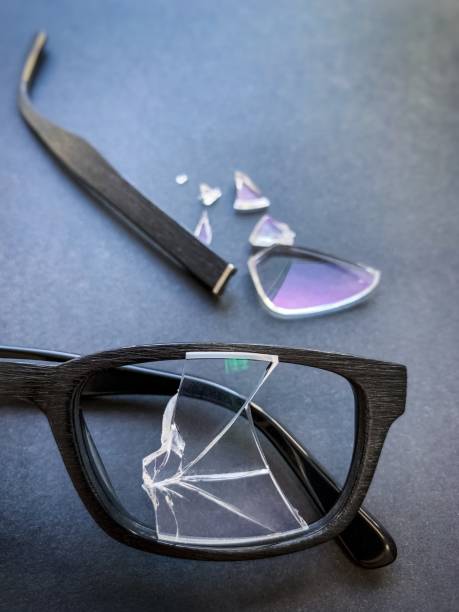 istock plastic glasses with a broken lens and a torn earhook on a dark background. 1185906817