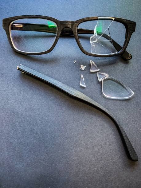 istock plastic glasses with a broken lens and a torn earhook on a dark background. 1185906832