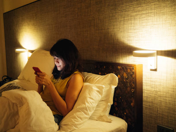 Asian woman using smart phone late in night.