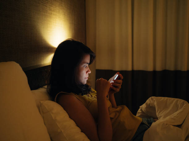 istock Asian woman using smart phone late in night. 1185908222