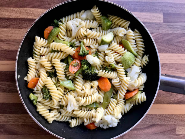 istock Fusilli Spiral Auger Pasta Spaghetti with Boiled Vegetables in Pan. 1185908527