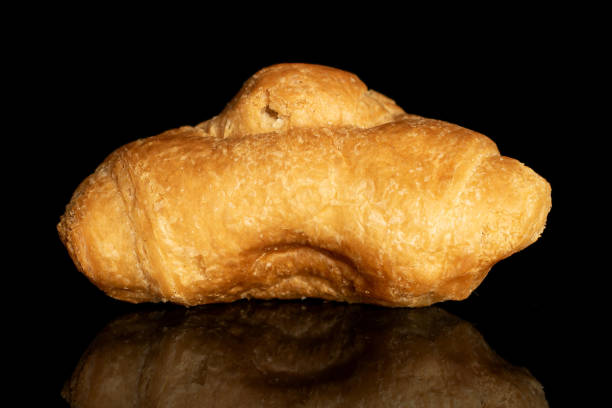 istock Fresh mini croissant isolated on black glass 1185911653