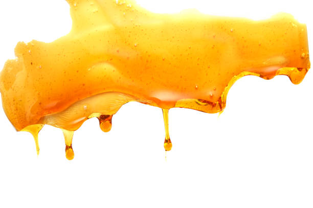 istock Honey drop isolated on white background. Dripping sweet honey 1185911814