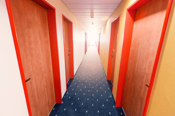 istock Empty Hotel corridor with row of doors 1185912048