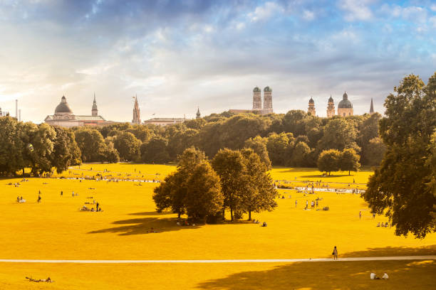 English garden and Munich skyline panoramic view English garden and Munich skyline panoramic view munich cathedral photos stock pictures, royalty-free photos & images