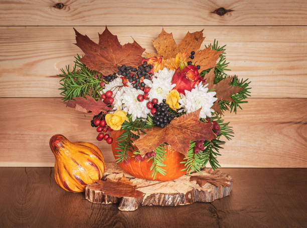 istock Flowers Bouquet in a Pumpkin Vase. 1185913921
