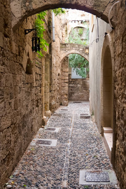 istock Narrow stone paved street. 1185914644