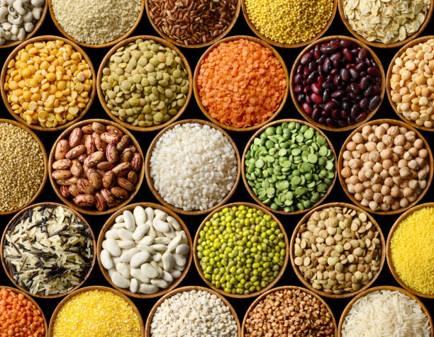 istock Various colorful legumes and cereals on black background 1185914861