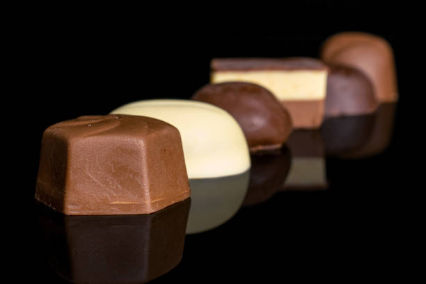 istock Chocolate praline candies isolated on black glass 1185916572