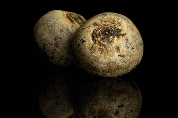 Raw red beetroot isolated on black glass