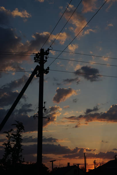 istock Old electric pole on a background of sunset cloudy sky 1185917180