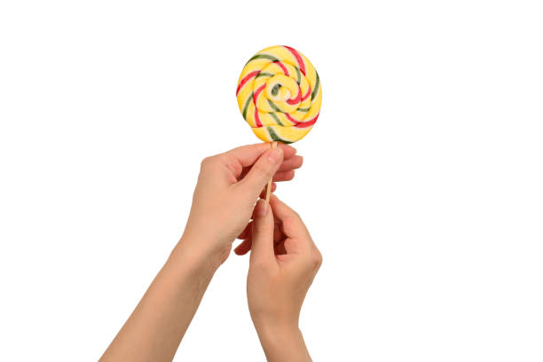 istock Lollipop in female hand isolated on white  background. Space for text or design. 1185918618