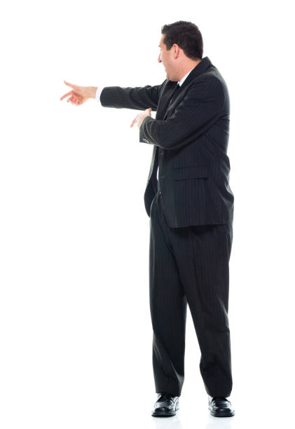 istock Side view / sideways glance / profile view / full length / front view / one man only / one person of adult handsome people caucasian male / young men presenter / manager / businessman / business person standing wearing businesswear / a suit 1185920537