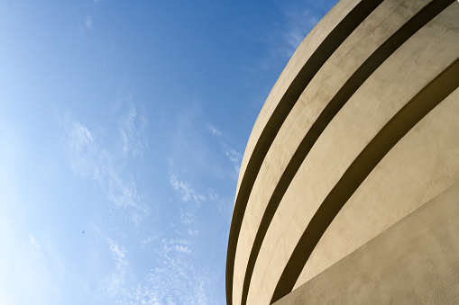 In New York City, United States the round exterior of the Guggenheim Museum is seen against a blue sky on a spring day.