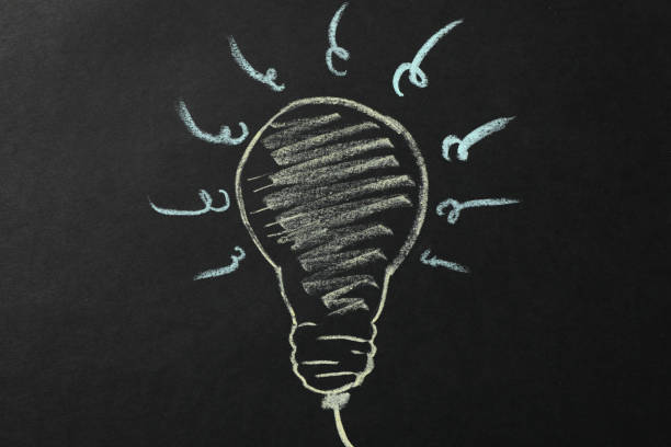 istock Chalk bulb on black background. Good idea concept 1185920699